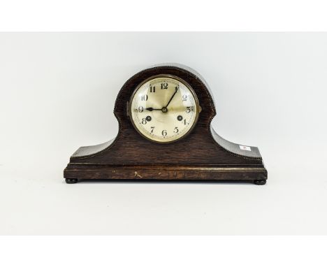 Mahogany Cased Helmet Shaped Mantle Clock with silvered dial and Arabic Numerals.