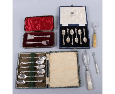 A cased set of silver teaspoons, a cased set of silver coffee spoons, a cased fork and pusher, a silver bladed butter knife, 