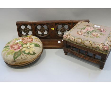 A Gothic design wall shelf, two embroidered footstools and an oval wall mirror, in painted and gilt frame