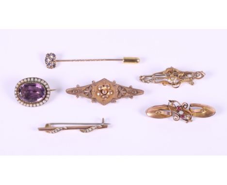 A 9ct gold floral design brooch mounted seed pearls, a similar seed pearl mounted bar brooch, two other 9ct gold brooches, a 