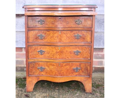 A figured walnut and banded serpentine front chest of four drawers with slide over, on bracket feet, 24" wide