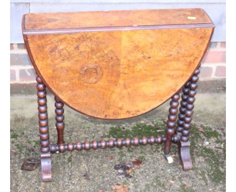 A late 19th century figured walnut oval Sutherland table, on bobbin turned supports, 24" wide