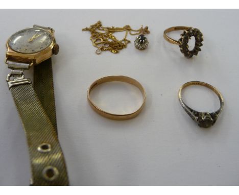 A 9ct gold cased wristwatch, faced by an Arabic dial; a gold coloured metal wedding ring; two dress rings; and a pendant, on 