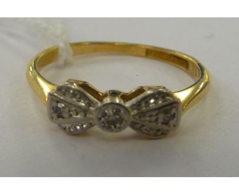 An 'antique' 18ct gold and platinum ring, fashioned as a bow tie, set with diamonds      11