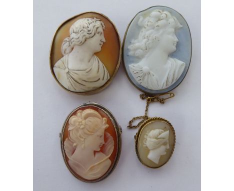 Three similar oval, shell carved cameo brooches, respectively featuring profile portraits of young women, in yellow/white met