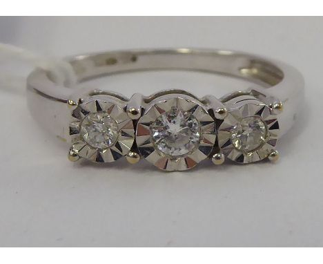 An 18ct white gold ring, set with three in-line diamonds       11