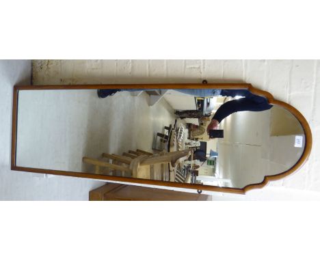 A 1950s Queen Anne inspired dressing mirror, set in a round arched, cushion moulded mahogany frame  50''h  16''w      BSR