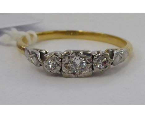 A bi-coloured metal ring, set with three in-line diamonds      11