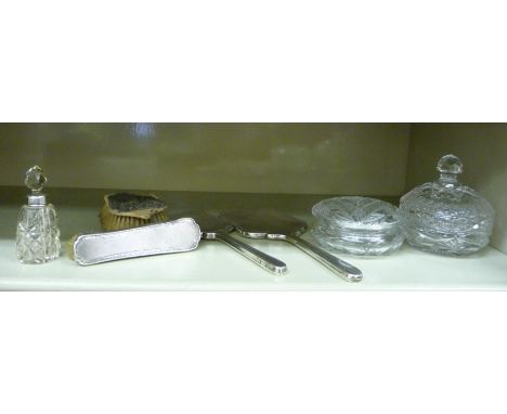 Dressing table items, viz. two cut crystal powder bowls; silver mounted brushes, a hand mirror and a glass perfume bottle wit