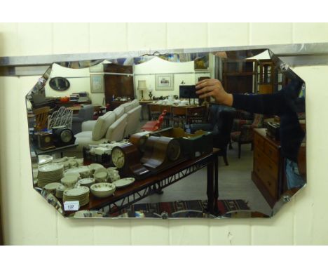 A 1930s mirror, the shaped, bevelled plate with canted corners, mounted on board  27'' x 16''       LSB