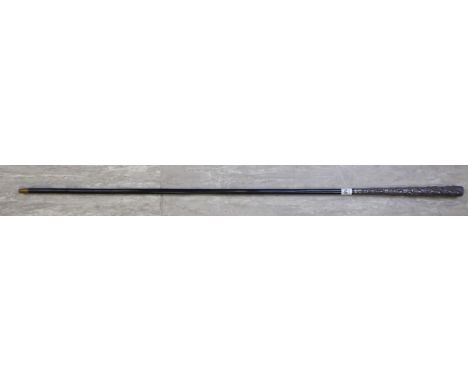 A mid 20thC Asian sword stick with a white metal handle, decorated with religious figures and a tapered ebonised shaft       