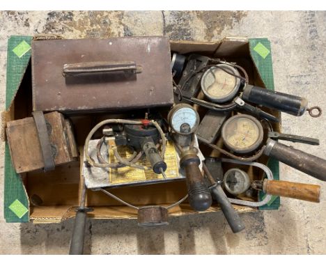 A box of workshop tools, including battery testers.