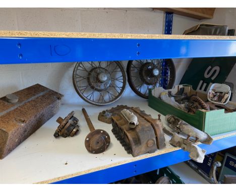 A collection of Austin 7 parts including engine block, wheels etc.