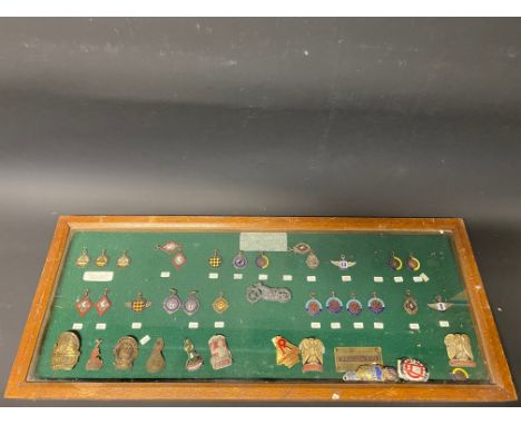 A framed and glazed collection of pre-war enamel motor club badges including Owls Motor Club, Ladies Motor Club, Gravesend &a
