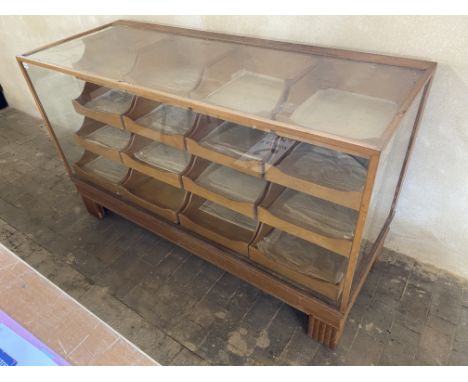 An Edwardian light oak shop counter habidashery type cabinet with pull out drawers to the rear, 60" w x 36" h x 23" d.