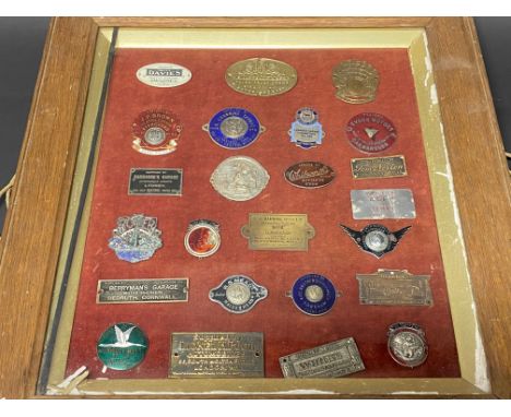 A framed and glazed collection of enamel and brass dash mounted supply plates, many Pembrokeshire and South Wales related.