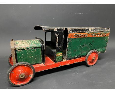 A large tinplate model of a delivery wagon, with advertising for Carter Paterson.