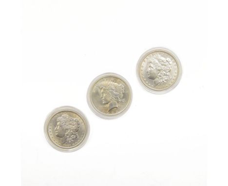 Two United States of America silver Morgan dollars dated 1881, 1883 and 1922 Liberty head peace dollar