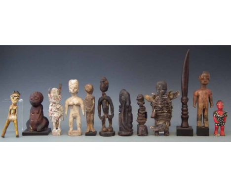 Twelve African figures, carved in various tribal styles, the tallest measures 27cm high       All lots in this Tribal and Afr