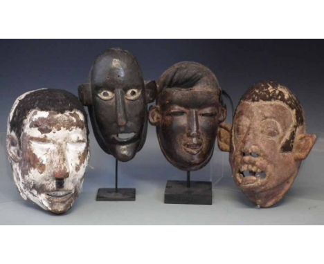 Four Makonde type face masks, the tallest measures 24cm high     All lots in this Tribal and African Art Sale are sold subjec