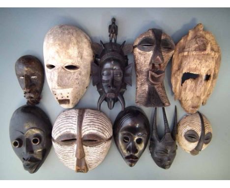 Ten masks carved in various tribal styles, the largest measures 31cm high     All lots in this Tribal and African Art Sale ar