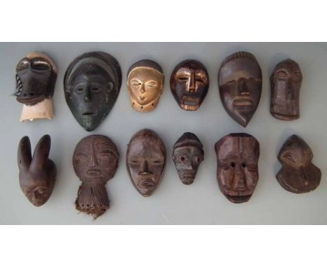 Twelve African passport masks, the largest measures 20cm high     All lots in this Tribal and African Art Sale are sold subje