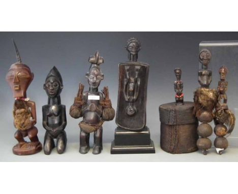 Two Yaka figures, Songye Nkisi and rattle, Luba/Hemba rattle and a panel, and a Fang box, the tallest item measures 33cm high