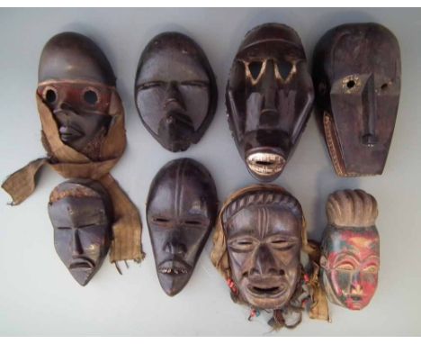 Eight African masks carved in Dan, Bete and other related tribal styles, the largest measures 26cm high     All lots in this 