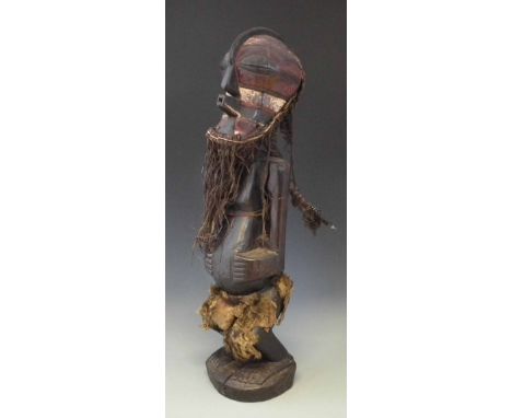 Songye Nkisi power figure wearing Kifwebe mask, 77cm high     All lots in this Tribal and African Art Sale are sold subject t