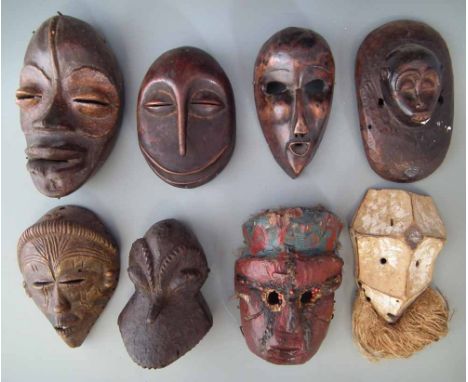 Eight African masks, carved in various tribal styles, the largest measures 24cm high     All lots in this Tribal and African 