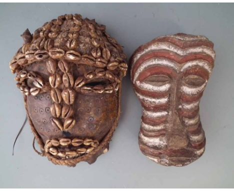 Lega mask, made from one section of animal bone applied with cowrie shells, also another all bone kwebe type mask, the first 