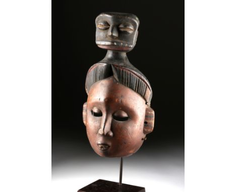 West Africa, Nigeria, Ibibio peoples, ca. early 20th century CE. An intriguing, hand-carved wooden face mask depicting an att