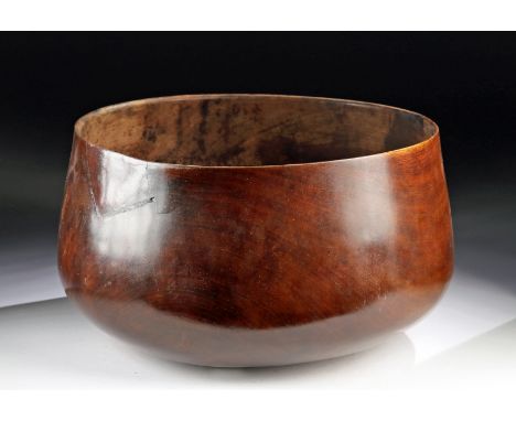 South Pacific, Hawaii, ca. early 20th century CE. A beautiful serving bowl carved from caramel-hued kamani wood, of a substan