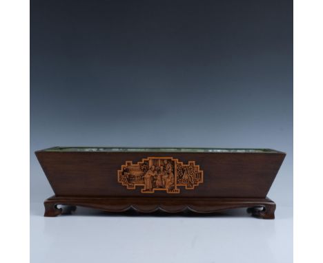 Wood planter with base and metal liner in rectangular form with carved relief on front and back. Wood base has scrolled legs 