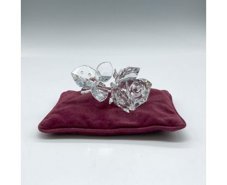 Lovely, faceted clear crystal figure with crystal rhinestones on leaves as dew. Figure has burgundy pillow included. Swarovsk