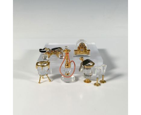 This five piece set includes drums with sticks, a radio, sparkling wine cooler with flutes, binoculars, and a water pipe. Eac