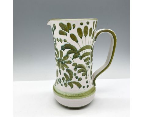 Slender tube-shaped pitcher with light glaze over green leaf design. Rim, handle and base has dark green banding. HH Italy ma