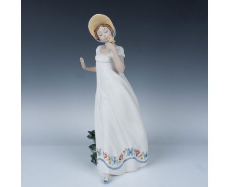 Features the figure of a woman holding a yellow flower in a white dress as she gracefully leans on a column. Nao Lladro backs