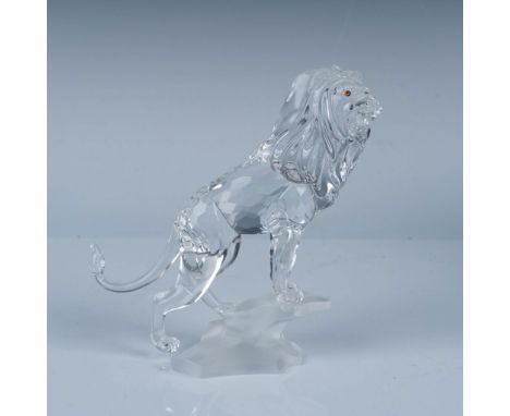 A majestic clear faceted figure of a lion standing on a frosted rock base, adorned with amber-hued eyes. Part of the Rare Enc