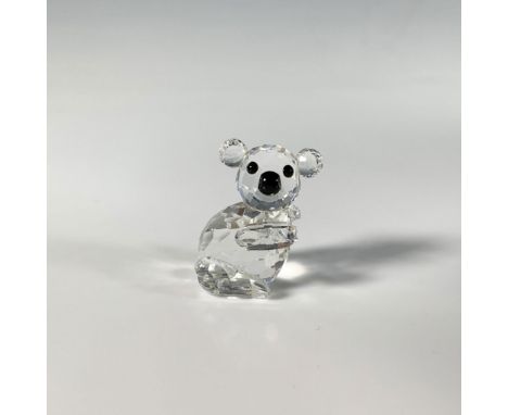 This playful precision cut crystal figure of a small koala bear features a black nose and eyes. Swarovski acid mark. This ite