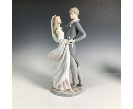 This grand, glossy ceramic figure depicts a romantic scene of a bride and groom sharing their first dance. Lladro backstamp. 