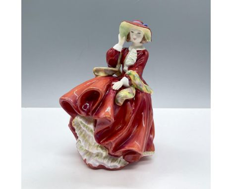 Glossy porcelain. Features a lovely lady on a windy day, wears a vibrant red dress with green scarf. Royal Doulton backstamp.