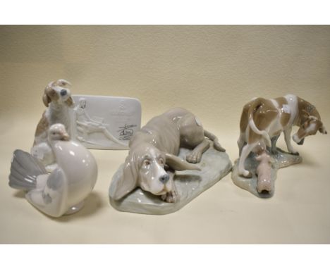 A cow and pig figure base by Lladro with similar porcelain plaque also two Nao dog figures and a porcelain pigeon