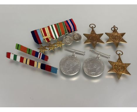 A set of group of four WW II medals and miniatures including the Africa Star, Italy Star and first Army bar (A lot)