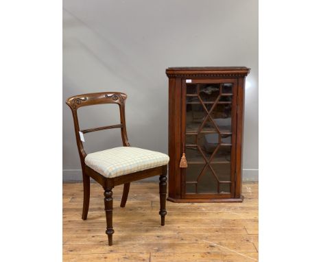 A George III mahogany wall hanging corner cupboard, with dentil cornice above an astragal glazed door enclosing two shelves. 