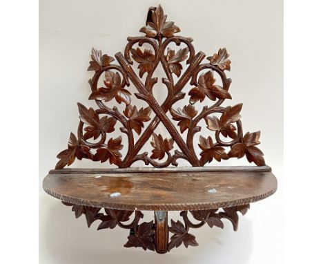 A Bavarian fretwork carved hardwood open wall shelf typically carved with vine leaves (h- 40cm, w- 38cm)