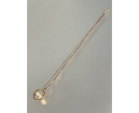 A 9ct gold circular open work pendant set two cultured pearls D x 2cm on 9ct gold chain necklace with ring fastening no signs