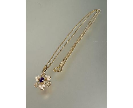 A 9ct gold openwork pendant in celtic style set central amethyst mounted in claw setting with three sets of three cultured pe