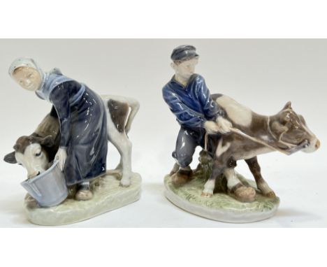 A Royal Copenhagen model of a lady feeding a cow (779) (marked verso h- 18cm, w- 18cm), together with a Royal Copenhagen figu