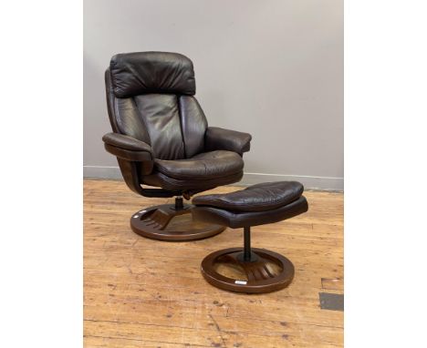 A Vintage faux leather upholstered reclining chair and footstool.&nbsp;